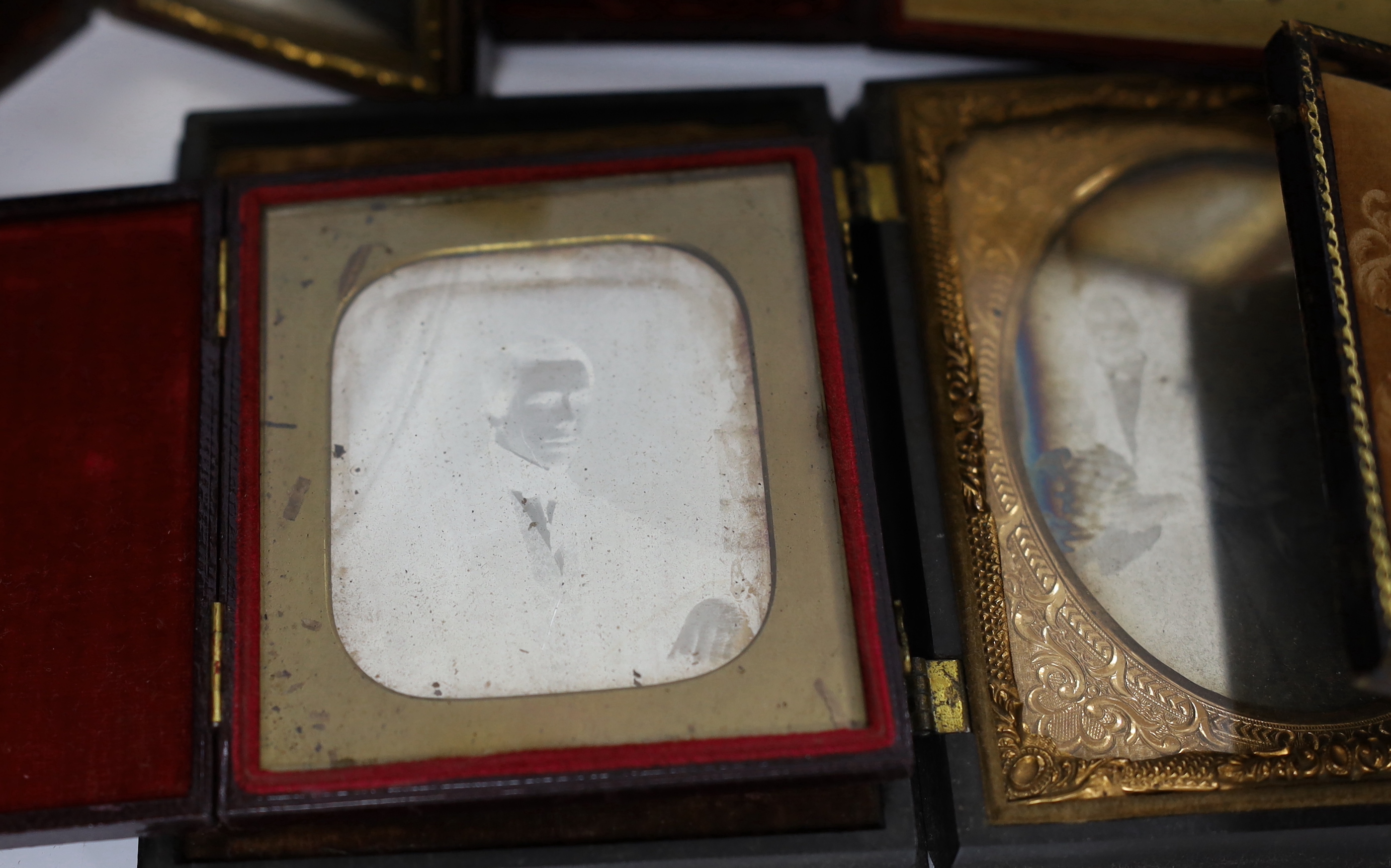 Nine mid 19th century daguerreotype portrait photographs, all mounted in brass, etc. frames, some in decorative cases, one example framed